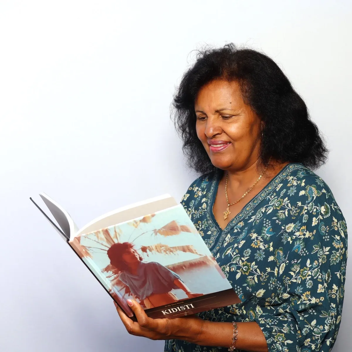 Kidisti reading her finished Legacy Storybook hardcover, In My Own Words.